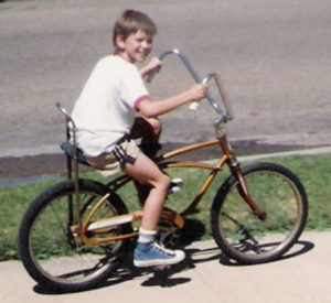 Brady riding a bike as a kid in the 80's.